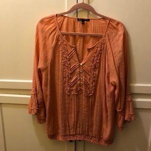 Peach colored long sleeve top with decorative trim